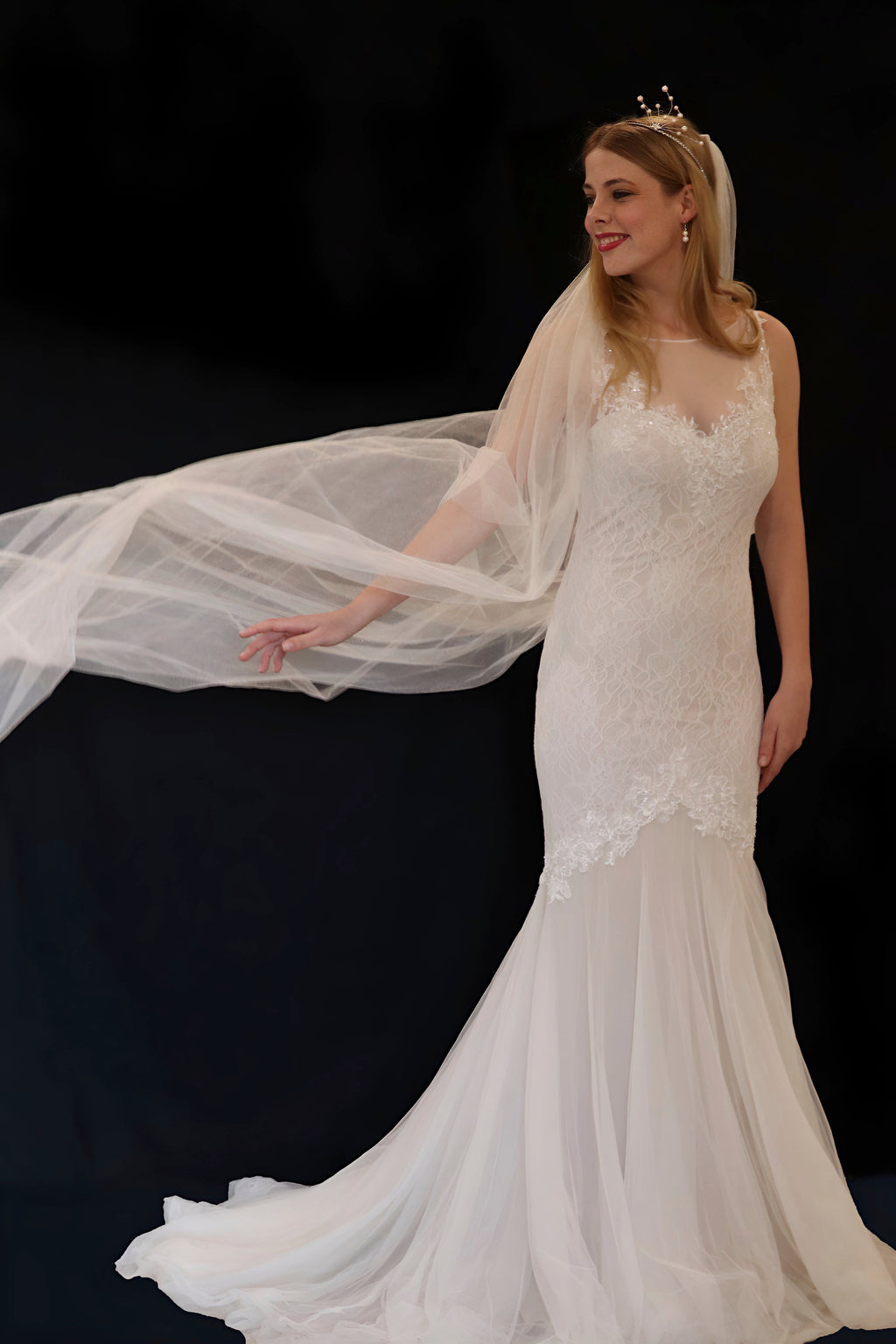 Woman in a white wedding dress with a long train 